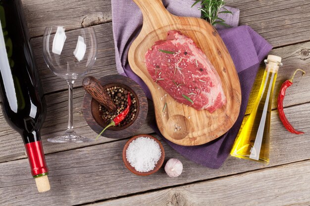 Raw beef steak with spices and herbs