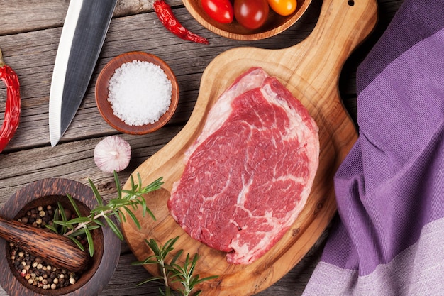 Raw beef steak with spices and herbs