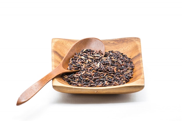 Raw of Black Jasmine Rice on the wood cup with wooden spoon