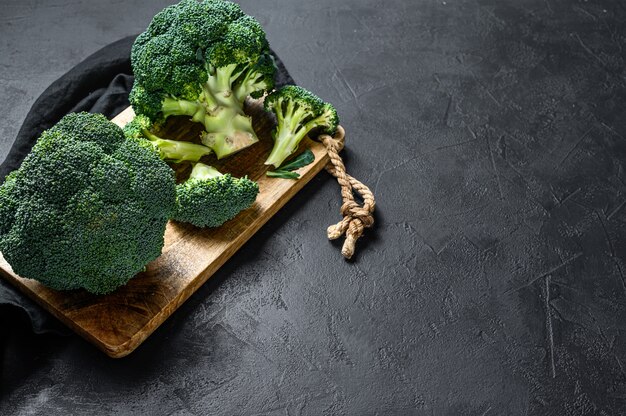 Raw broccoli in a wooden bowl. Top view.