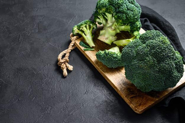 Raw broccoli in a wooden bowl.