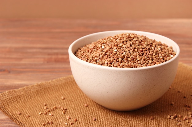 Raw buckwheat on a colored background closeup