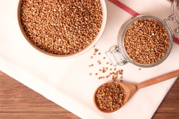 Raw buckwheat on a colored background closeup