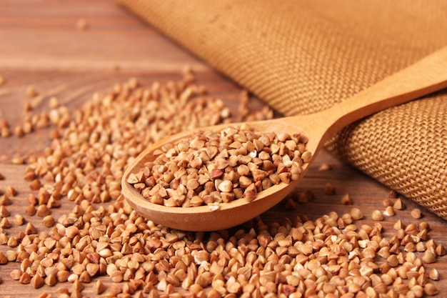 Raw buckwheat on a colored background closeup