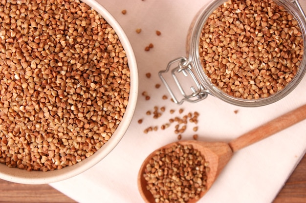 Raw buckwheat on a colored background closeup