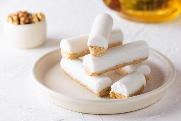 Raw carrot cakes on a plate with green tea. Sugar, gluten and lactose free.