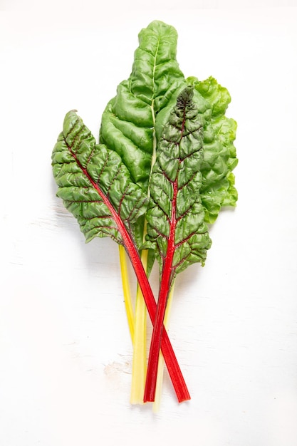 Raw chard on light background Highly nutritious leaves Popular component of healthy diets Top view copy space