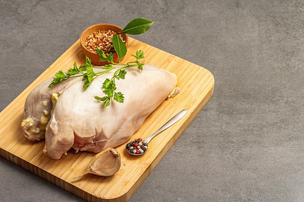 Raw chicken breast with spices and fresh parsley Farm product BIO poultry Healthy food concept