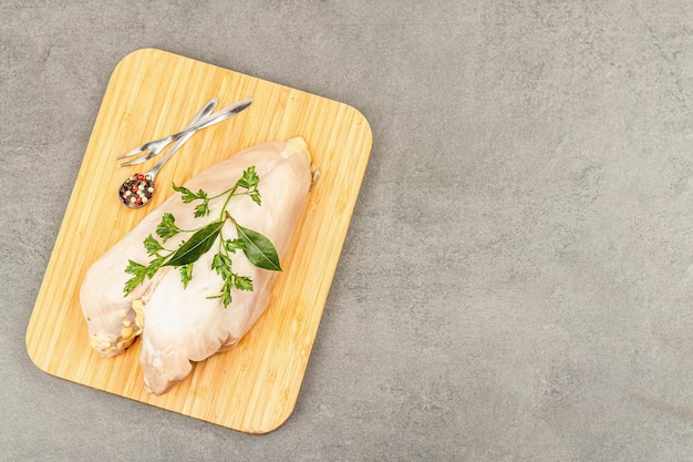 Raw chicken breast with spices and fresh parsley Farm product BIO poultry Healthy food concept