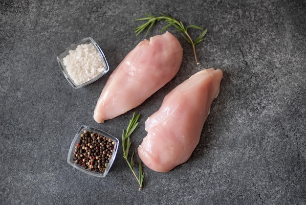 Raw chicken fillet on stone background