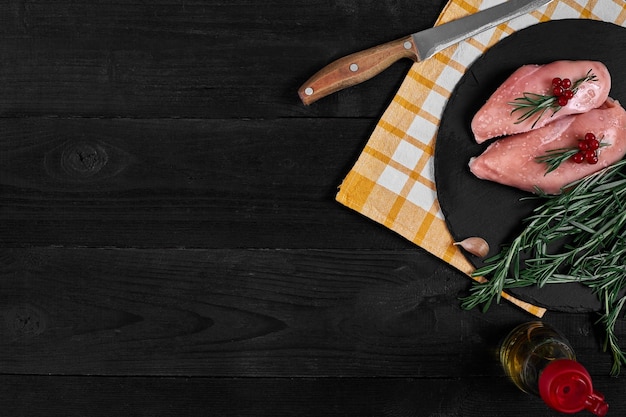 Raw chicken fillet with cooking ingredients on black slate table Food background Top view copy space Still life Flat lay