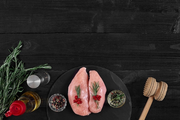 Raw chicken fillet with cooking ingredients on black slate table Food background Top view copy space Still life Flat lay