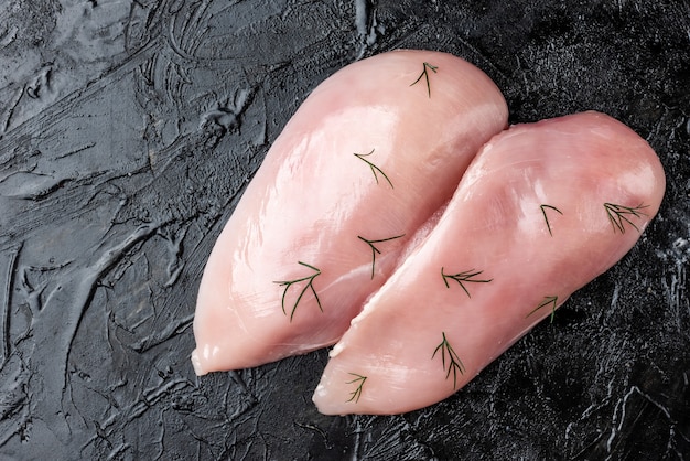 Raw chicken fillets with seasoning