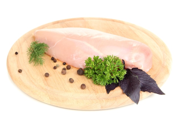 Raw chicken fillets on wooden board isolated on white