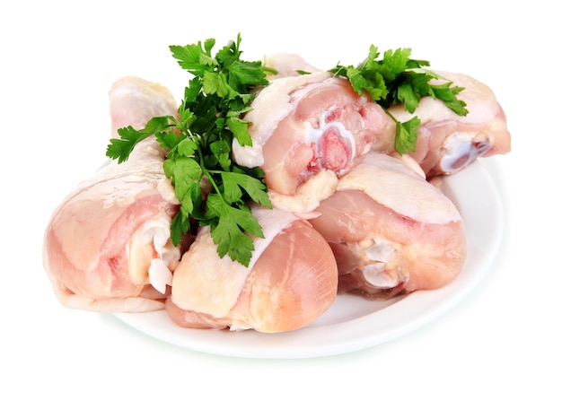 Raw chicken legs on white