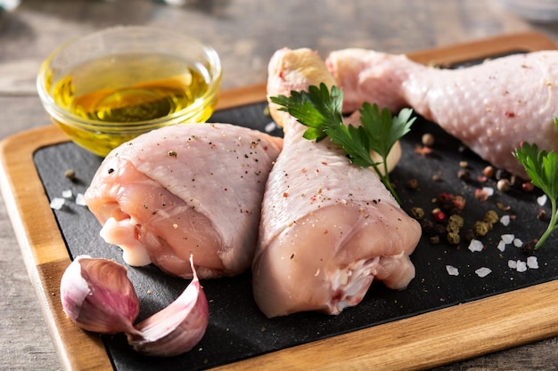 Raw chicken meat legs with spices and herbs