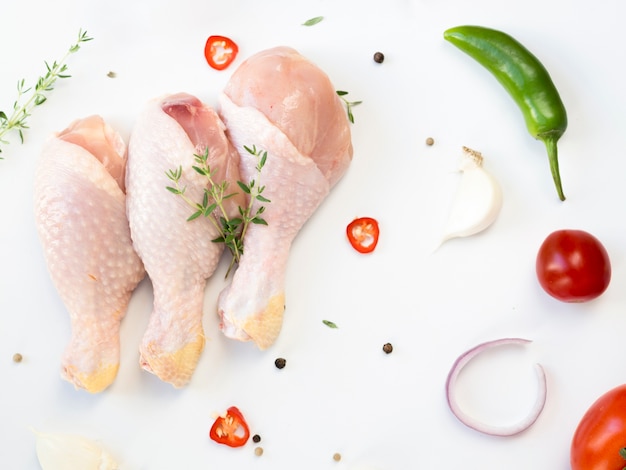 Raw chicken parts with different ingredients