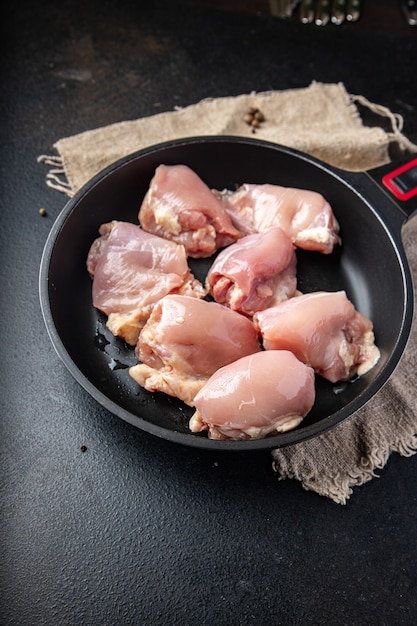 Raw chicken thigh boneless pulp meat poultry or turkey fresh ready to eat meal snack on the table