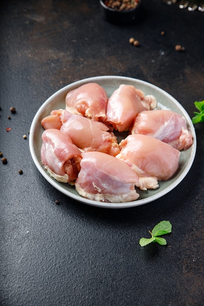 Raw chicken thigh boneless pulp meat poultry or turkey fresh ready to eat meal snack on the table