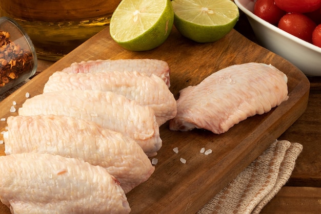 Raw chicken wings on cutting board Selective focus