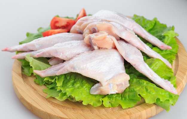 Raw chicken wings on white