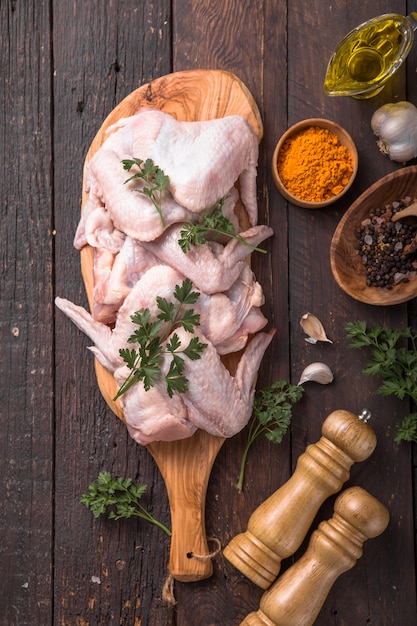 Raw chicken wings with ingredients for cooking