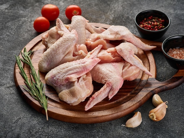 Raw chicken wings with pepper and salt Poultry meat on a grey background Close up