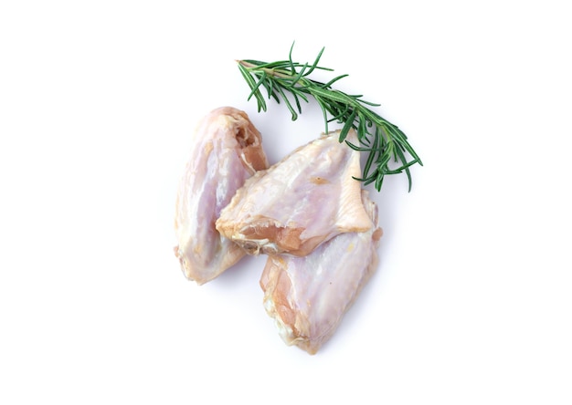 Raw chicken wings with rosemary isolated on white background