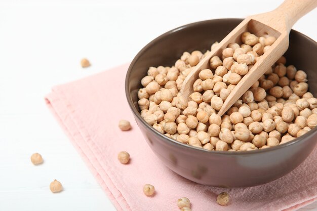 Raw chickpeas on the table on a light background closeup