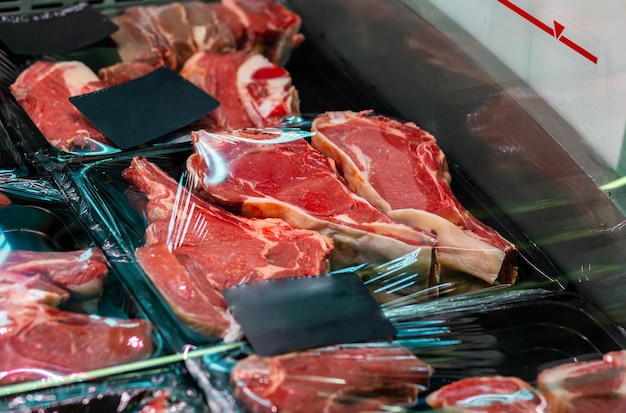 Raw chilled vacuumpacked pork steaks on a shop window