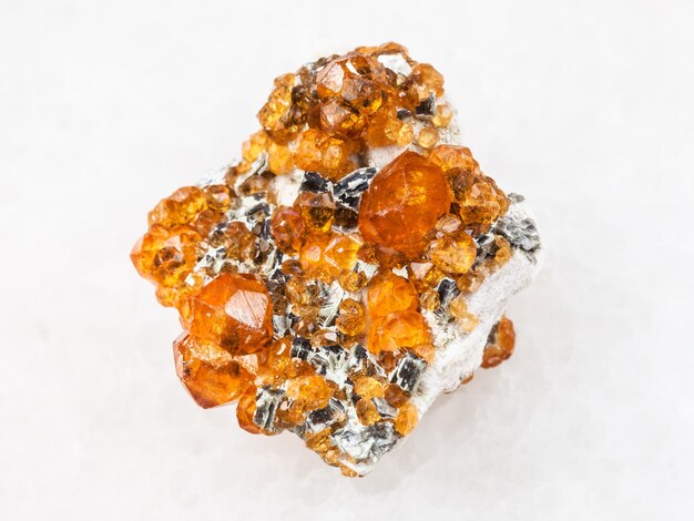 Raw crystals of spessartine garnet stone on white