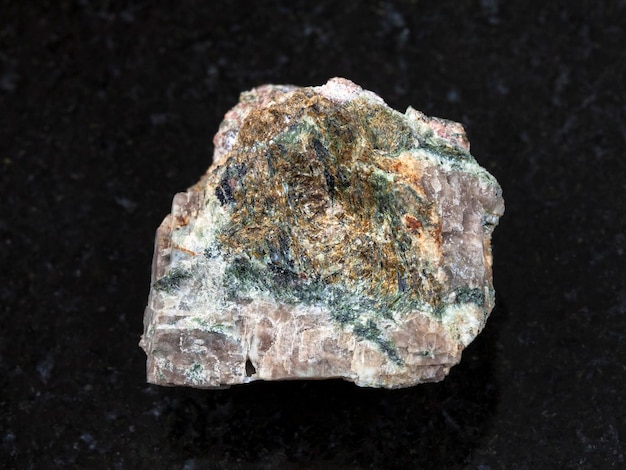 Raw Delhayelite stone on dark background