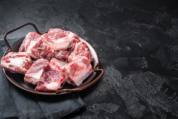 Raw diced beef and lamb marbled meat in kitchen steel tray Black background Top view Copy space