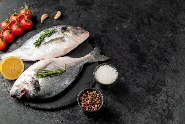 raw dorado fish on stone background with copy space for your text