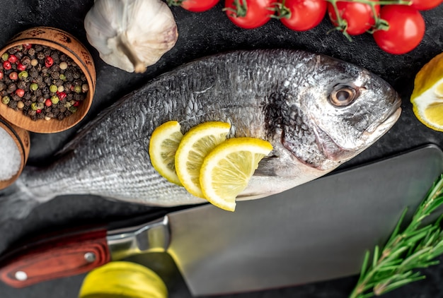 raw dorado fish on stone table