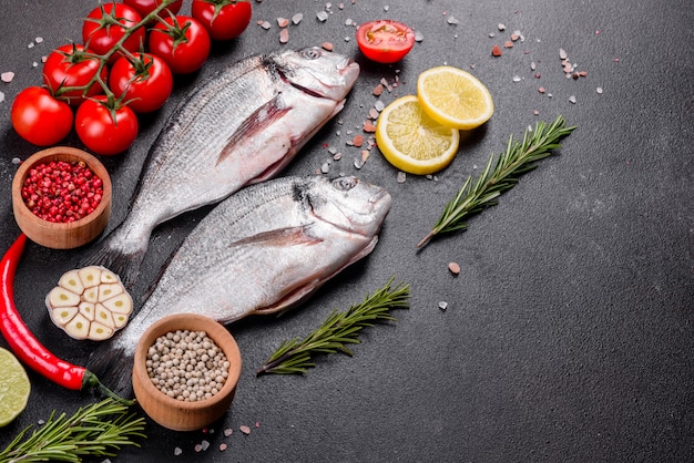 Raw dorado fish with spices cooking on cutting board. Fresh fish dorado. Dorado and ingredients for cooking on a table