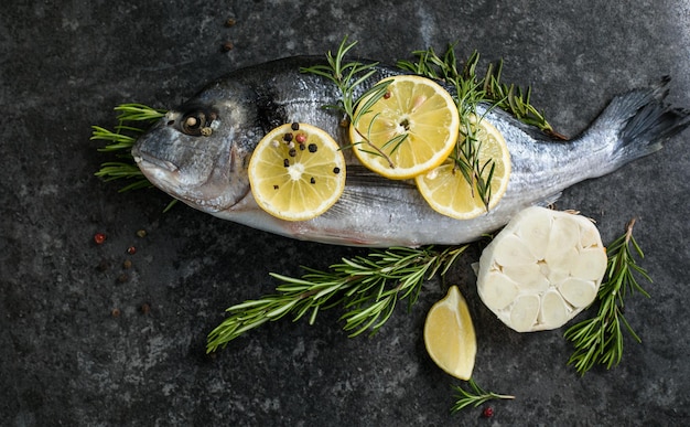 Raw dorado fish with spices Dorado and ingredients for cooking on a table