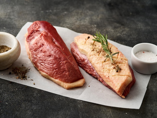 Raw duck breast fillet for cooking on the white paper