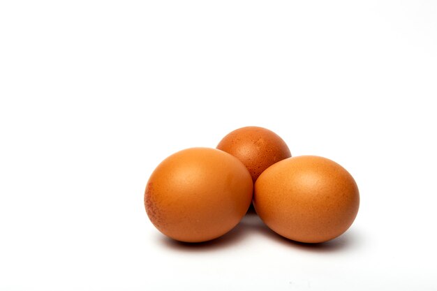 Raw eggs on white background