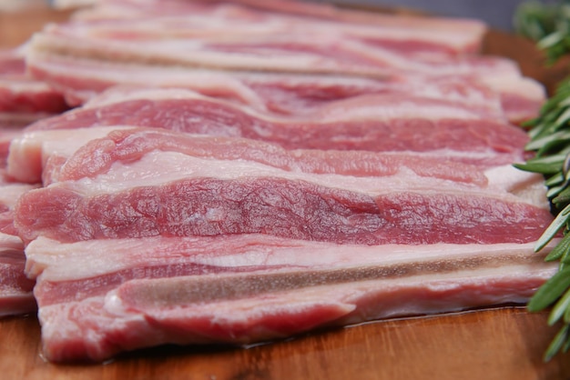 Raw fed bacon strips on chopping board