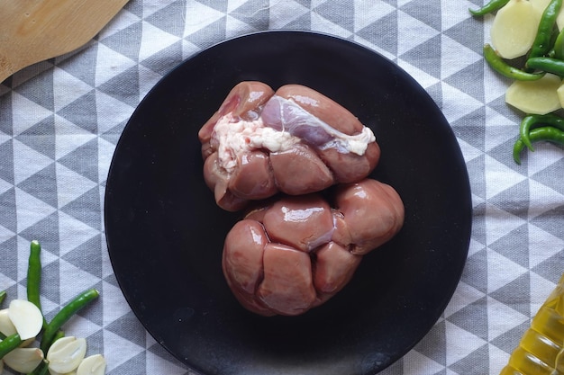 Raw fresh lamb kidneys on a chopping board