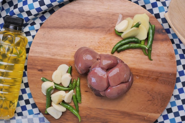 Raw fresh lamb kidneys on a chopping board