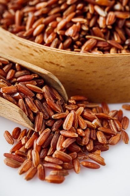 raw fresh red rice on a white background