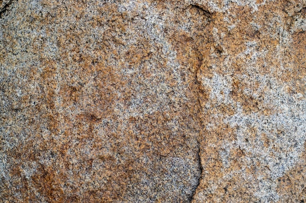 Raw gray granite rock texture background Fragment of natural stone wall