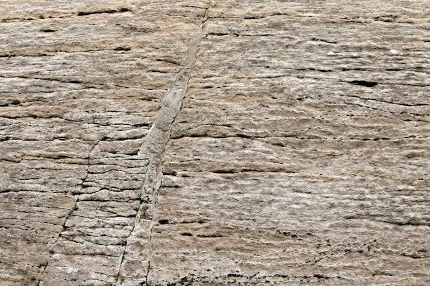 Raw gray stone texture with cracks