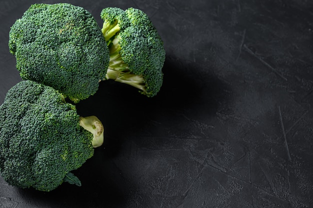 Raw green broccoli on a wooden bowl