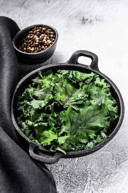 Raw Green Kale salad in a pan. Organic Vegetarian food. Top view