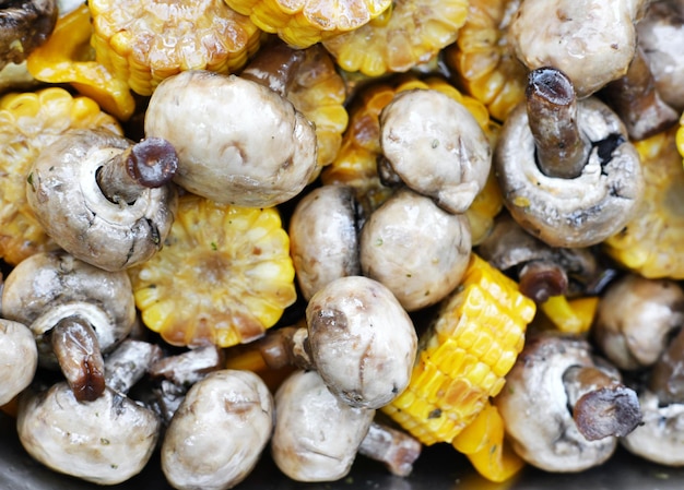 Raw grilled vegetables on a metal tray Corn mushrooms and peppers ready for frying Horizontal photo