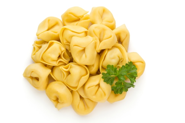 Raw homemade pasta,tortellini with herbs.