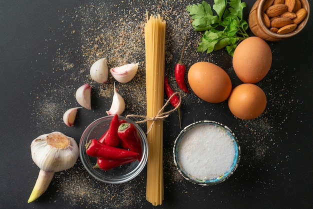 Raw ingredients for cooking spaghetti marinara with poached eggs flat lay and copy spaces